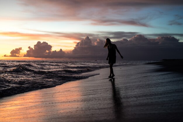 people on the beach at sunset. 