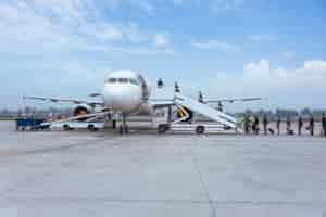 Free photo people boarding airplane on runway