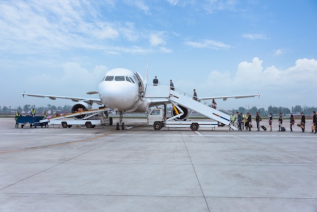 people boarding airplane on runway