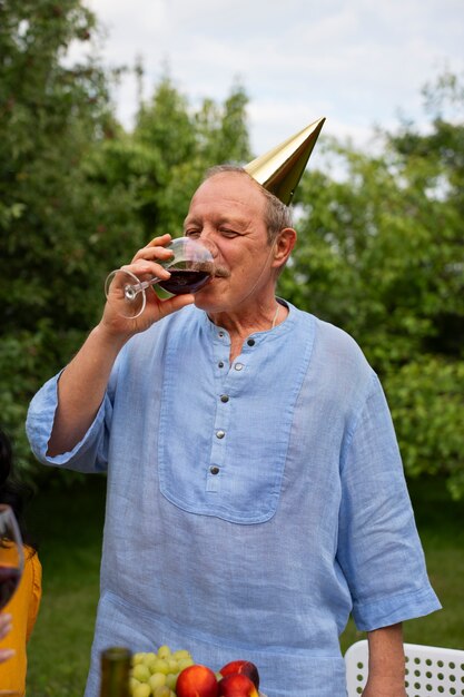 People celebrating a senior birthday party outdoors in the garden