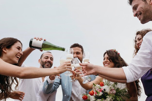 People celebrating with their friends getting married on the beach