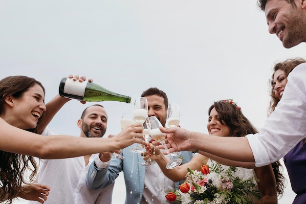 People celebrating with their friends getting married on the beach