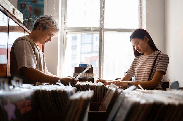 People checking vinyl records side view