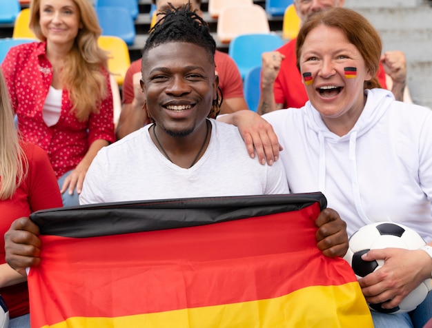 Free Photo people cheering for their country football team