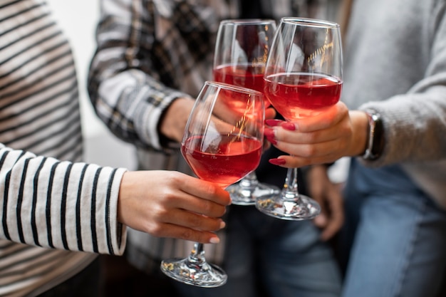 People cheering with glasses of wine