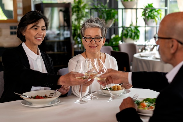 People cheering with wine glasses at a luxurious restaurant