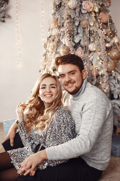 People in a Christmas decorations. Man in a gray sweater. Family at home.