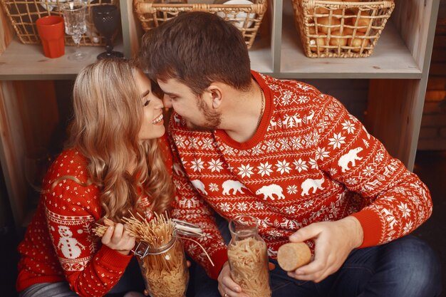 Free Photo people in a christmas decorations. man and woman in a red sweater.