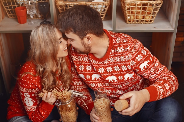 People in a Christmas decorations. Man and woman in a red sweater.