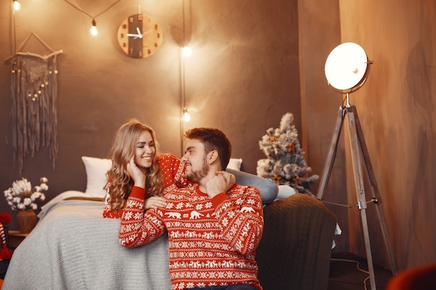 People in a Christmas decorations. Man and woman in a red sweater.