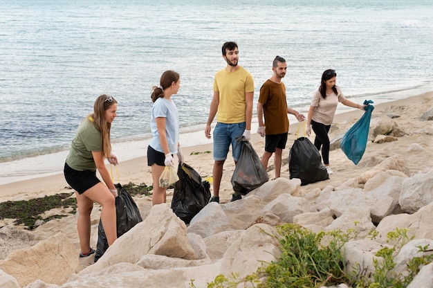 Free photo people cleaning garbage from nature