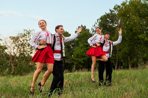 People dancing outdoors full shot