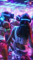 Free photo people dancing surrounded by bright neon lights at a party with virtual reality headset