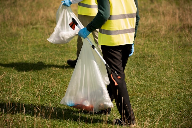 Free Photo people doing community service by collecting trash together