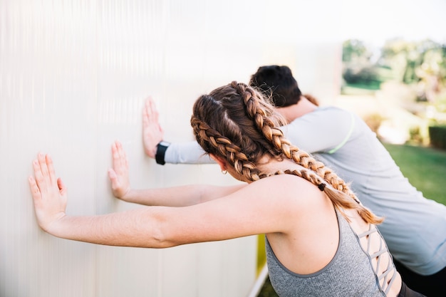 Free Photo people doing exercises near wall