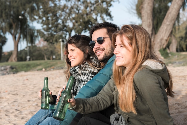 Free photo people drinking beer on seashore