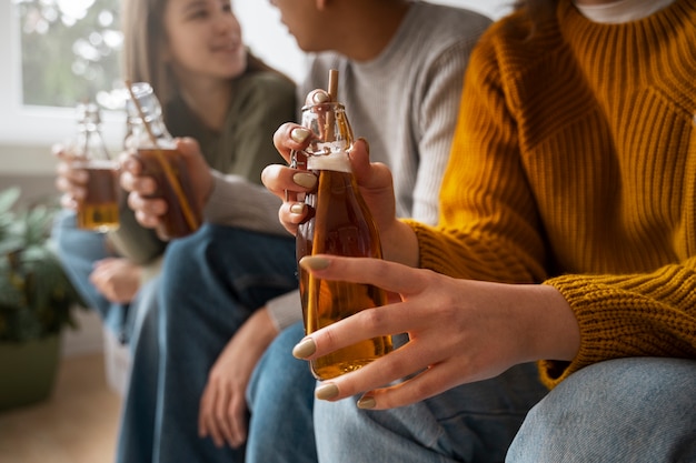 Free photo people drinking kombucha at a gathering