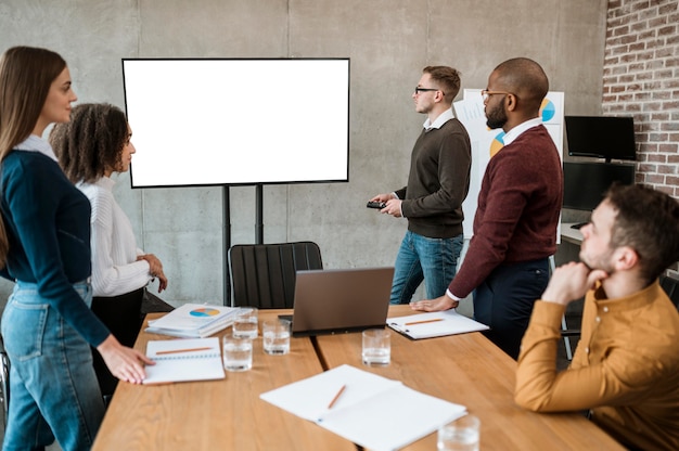 Free photo people during a meeting showing a presentation