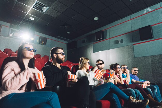 People eating popcorn and watching movie