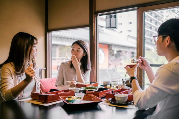 People eating with chopsticks close up