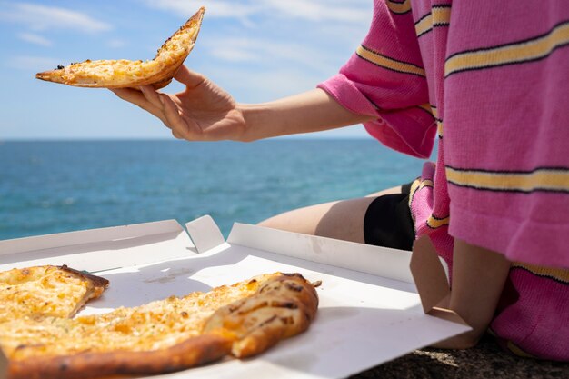 People enjoying a pizza snack outdoors