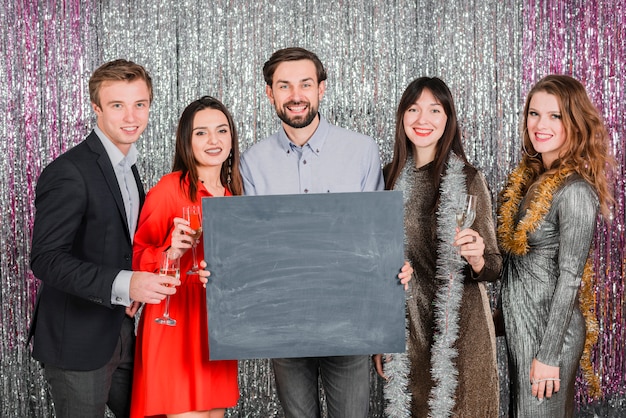 People in festive outfit holding champagne flutes