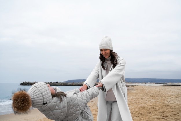 Free photo people going for a walk in the seaside in winter