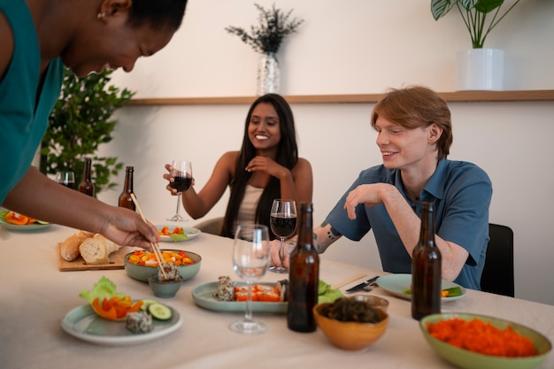 People having food and drinks at a dinner party