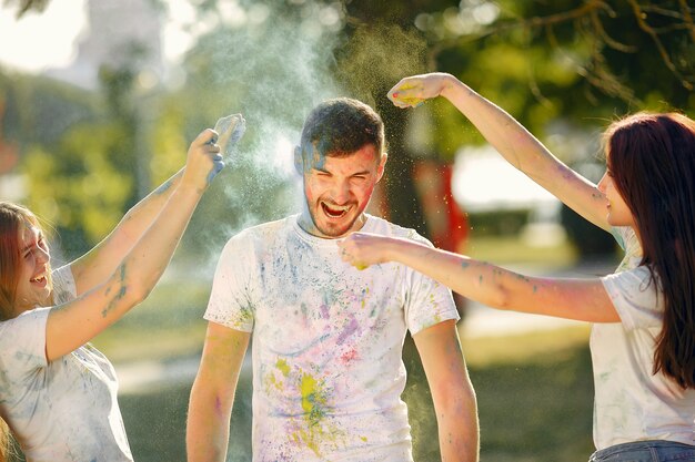 People having fun in a park with holi paints