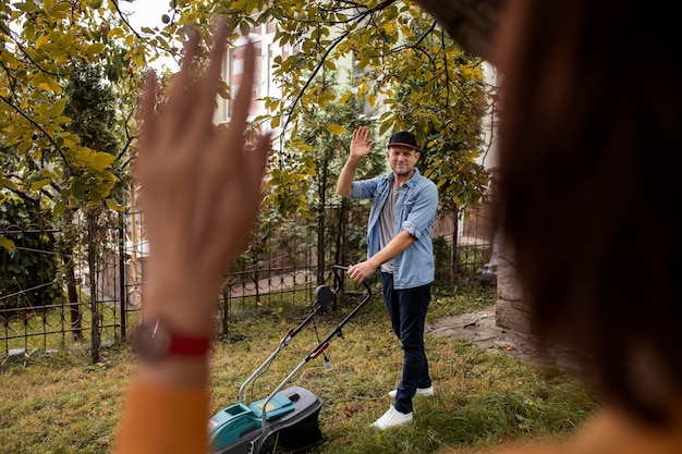 Free photo people helping neighbors with grass lawn