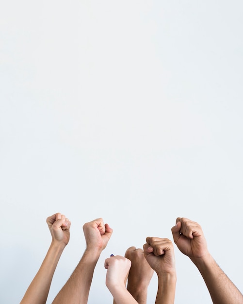 People holding fists up together