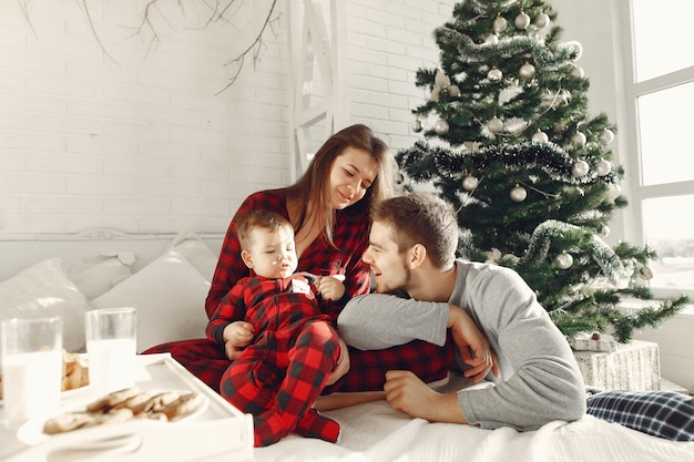 People at home. Family in a pajamas. Milk and croissants on a tray.