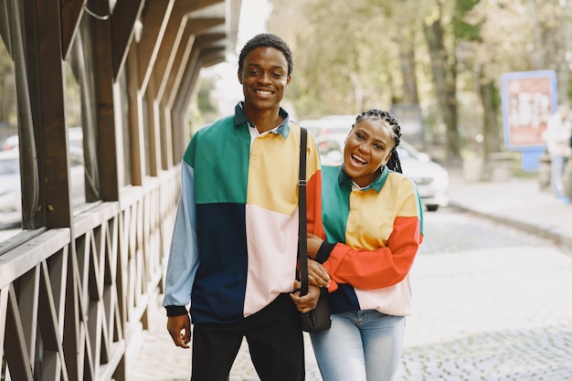 Free Photo people in identifical clothes. african couple in autumn city.