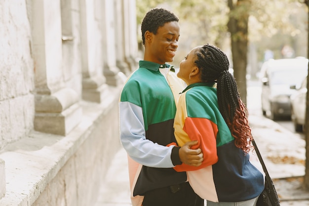 Free Photo people in identifical clothes. african couple in autumn city.