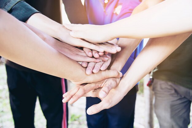 People join hand together during their work - human commitment concept