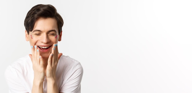 People lgbtq and beauty concept closeup of beautiful gay man with polished nails laughing and lookin