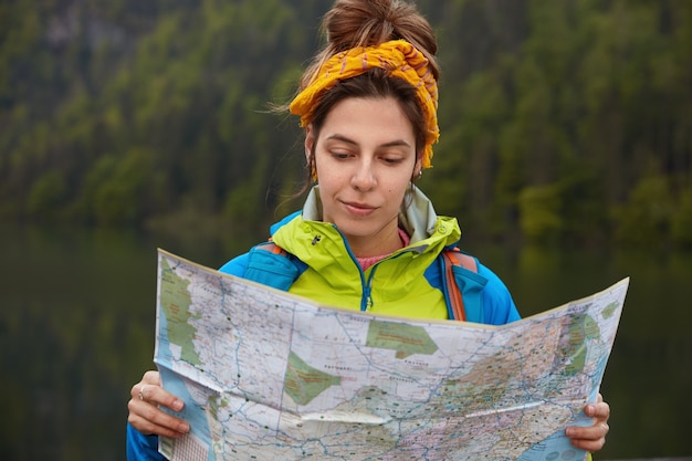 Free Photo people, lifestyle, traveling concept. serious tourist spends summer vacation near beautiful lake