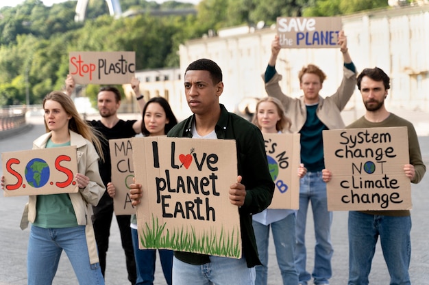 Free photo people marching together in global warming protest