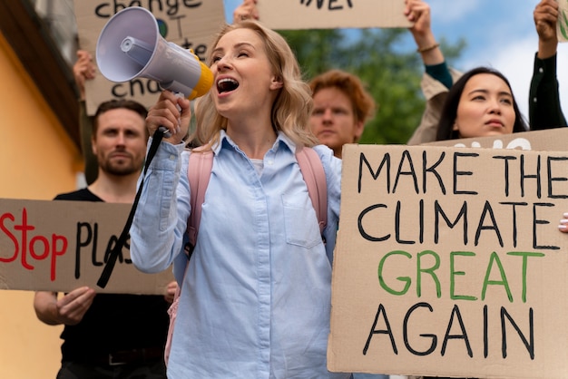 Free photo people marching together in global warming protest