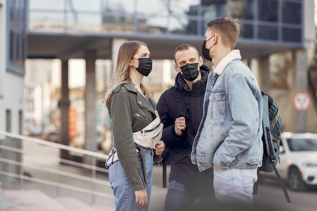 People in a masks stands on the street