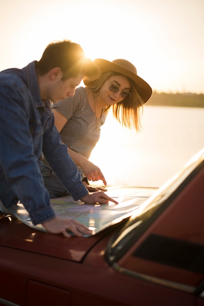 Free photo people navigating with map on a road trip