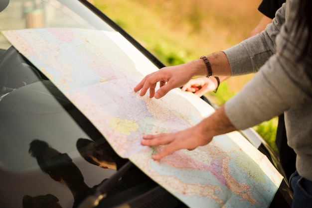 Free Photo people navigating with map on a road trip