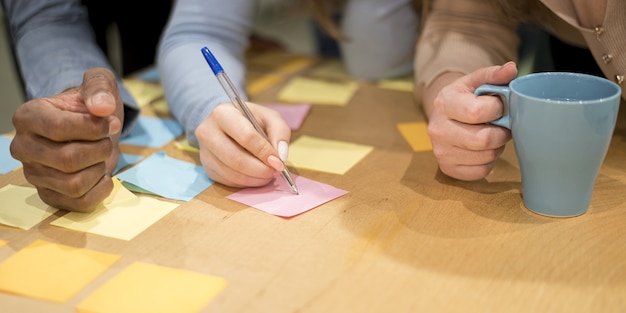 People at the office writing ideas on sticky notes