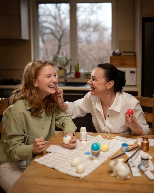 Free photo people painting eggs at home in celebration of greek easter