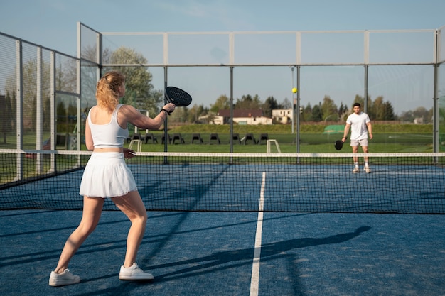 People playing paddle tennis full shot