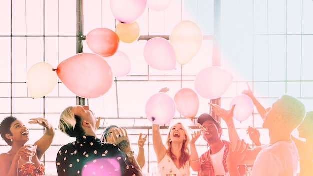 Free photo people playing with balloons at a party wallpaper