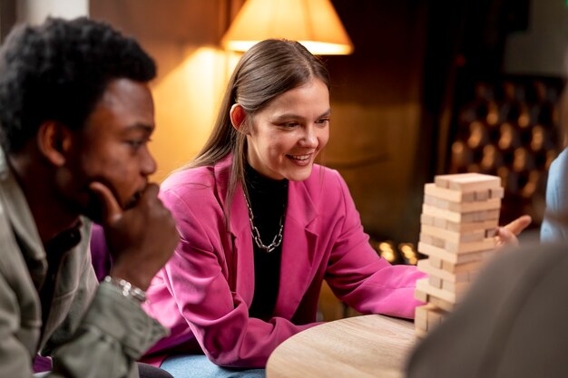 People playing a wooden tower game