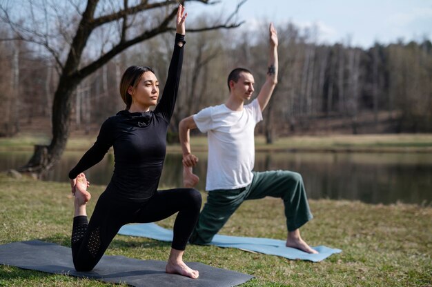 People practicing yoga outside