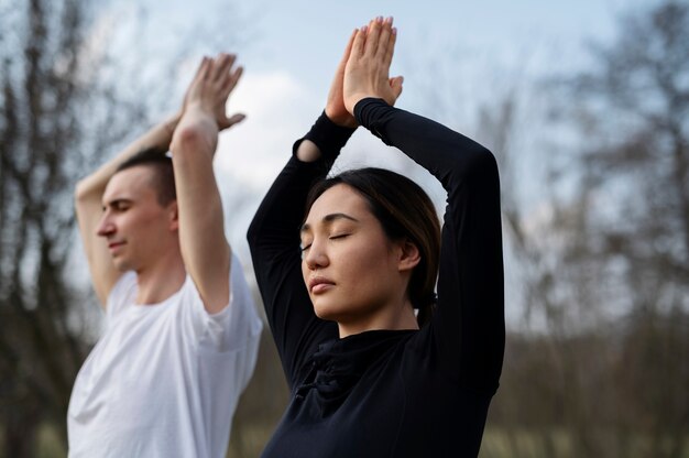 People practicing yoga outside