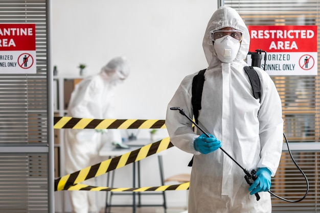 People in protective equipment disinfecting a dangerous area